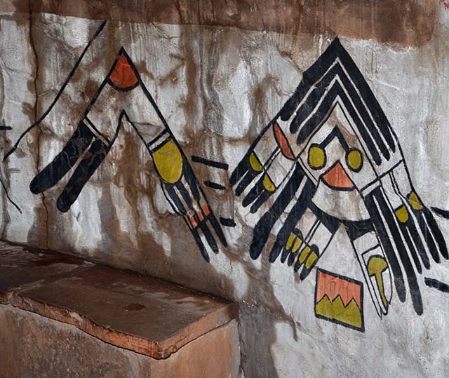water seeping through a masonry into murals of American Indian designs.