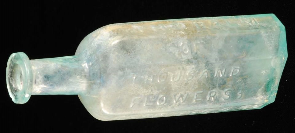 Glass bottle with raised lettering