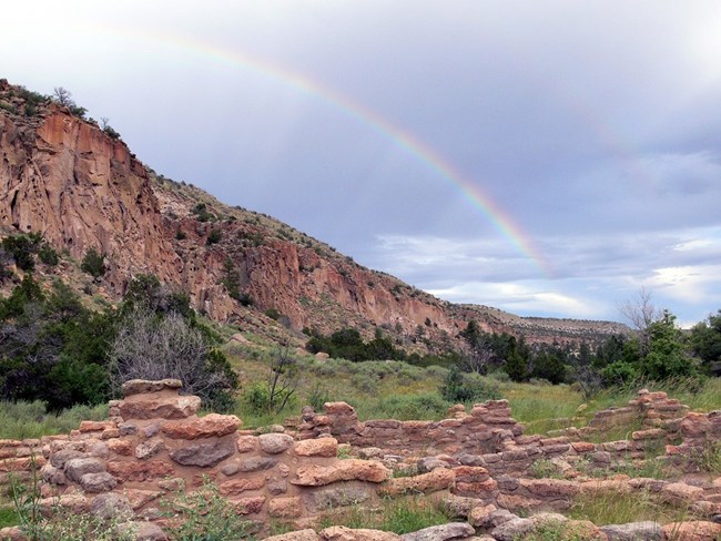 Rainbow over scenic desert and ruin in Bandelier NM