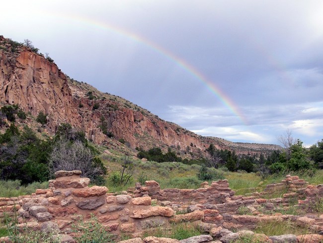 Rainbow over scenic desert and ruin in Bandelier NM Rainbow over scenic desert and ruin in Bandelier NM