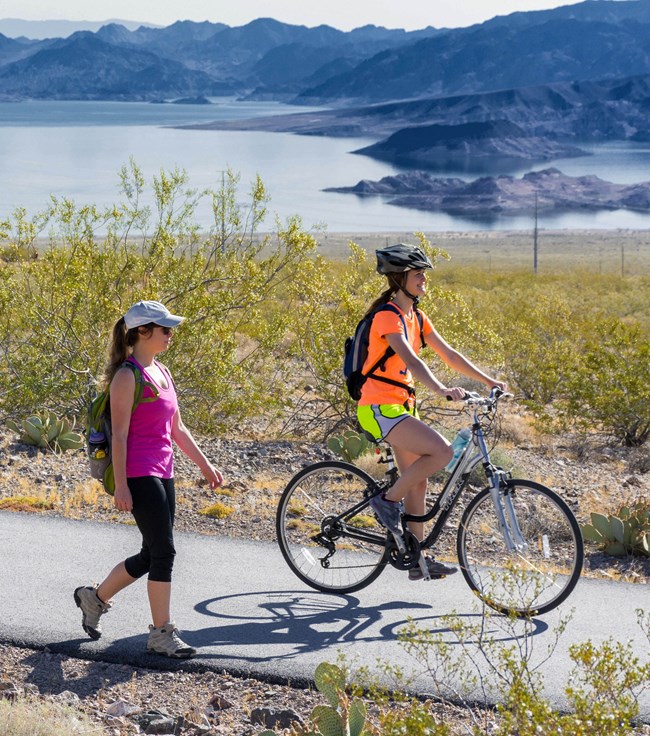 Cyclist and person walking on a path at Lake Mead
