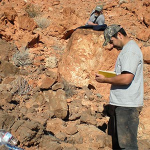 Bonde 3 scientist taking notes at rock outcrop