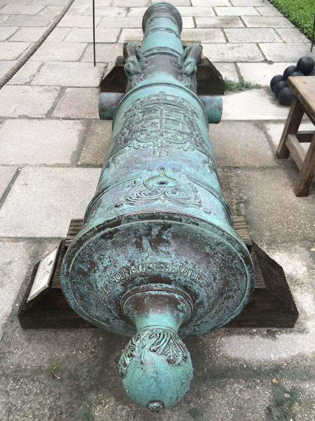 Bronze cannon with decorative engravings.