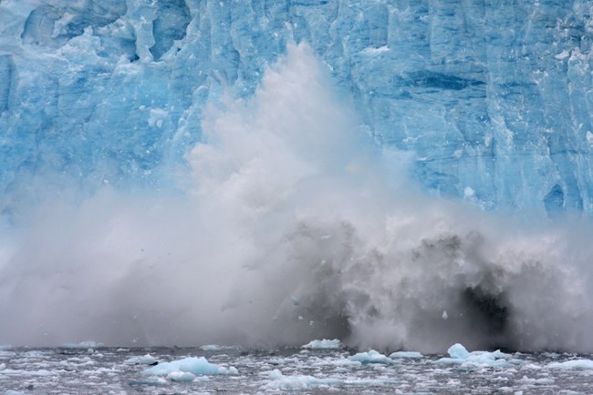 Calving Glacier in Aialik Bay Chunks of ice fall into the ocean off the front of a glacier.