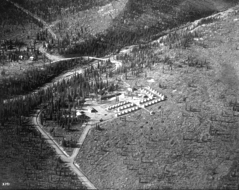 aerial view of tents lined up near a creek