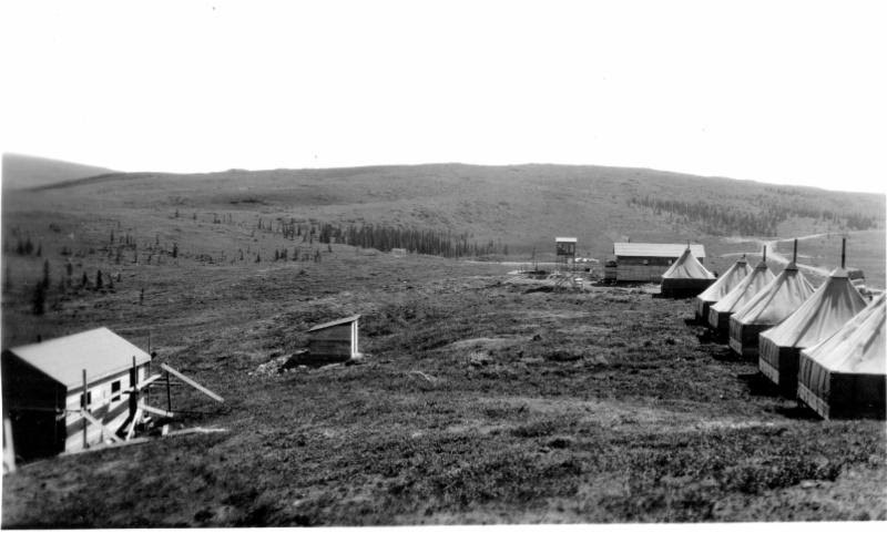 large tents lined up on an un-forested hill