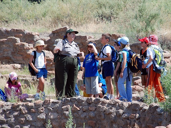 chris-with-kids-at-big-kiva_1 A ranger teaches kids about a Kiva at Bandelier National Monument NPS