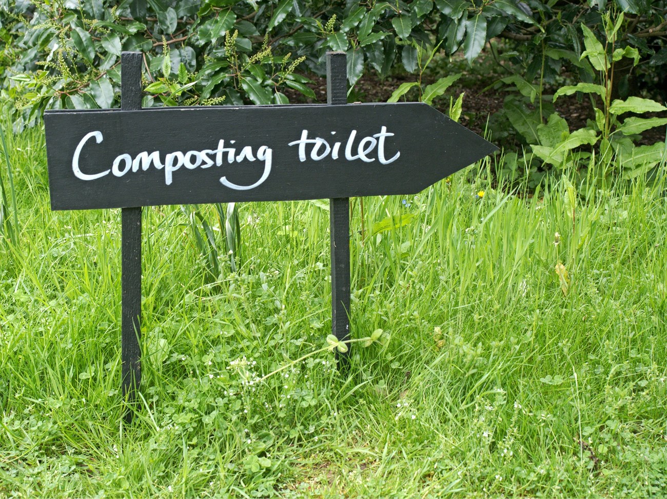 composting toilets wooden sign