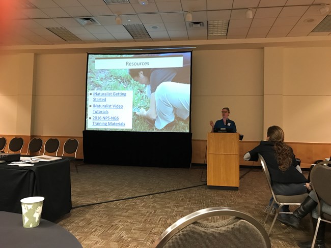 CSP Program Lead Kelly Coy speaking in front of a screen and a room full of people at the Citizen Science Association conference