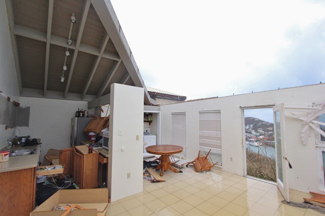 Interior of a residence with hurricane damage and missing roof