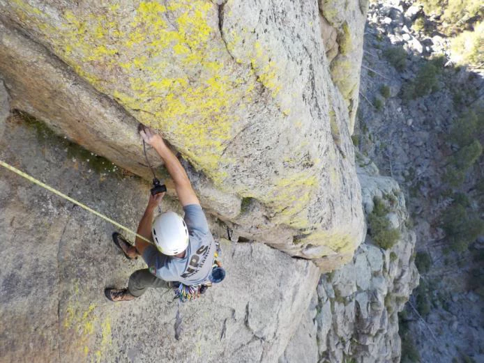View from above of a climber suspended on the side of Devils Tower View from above of a climber suspended on the side of Devils Tower