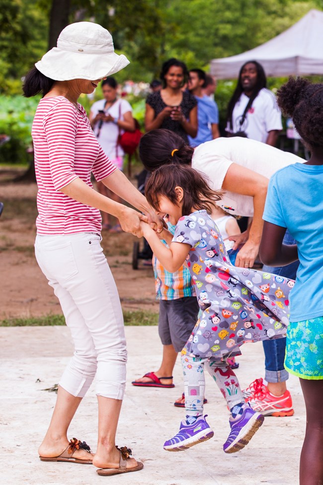 A young girl dances with a woman on the dance floor