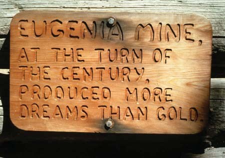 Sign from miners cabin near the mine. Says: At the turn of the century produced more dreams than gold.