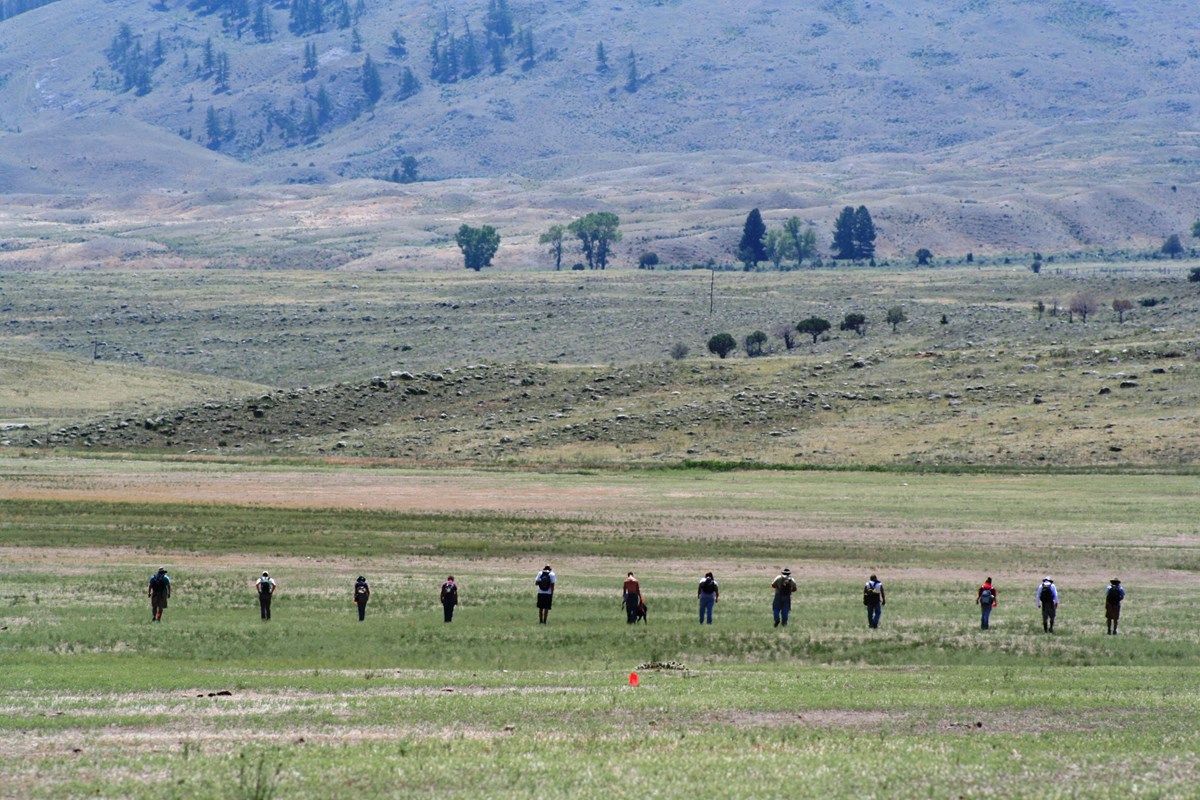 Archeologists out walking in a field Archeologists out walking in a field
