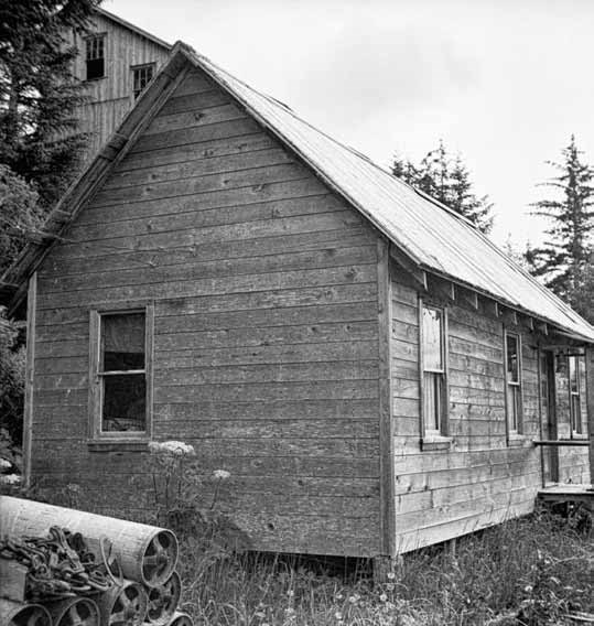 lt= Black and white photo of a wood framed building.