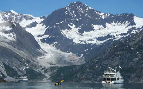 A cruise ship, kayak, and tour boat in Glacier Bay