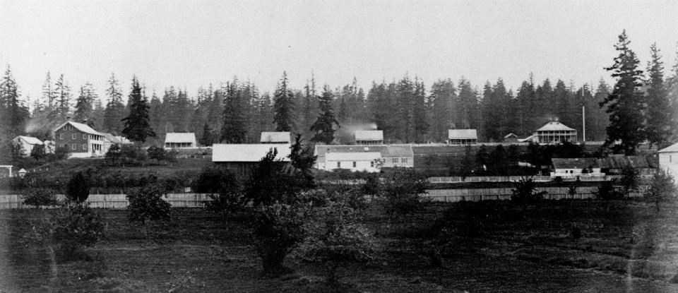 Black and white photograph of Officers' Row with flagstaff in upper right corner