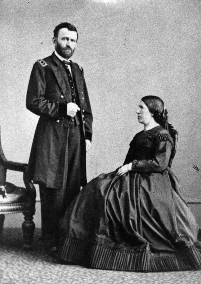 Ulysses S. Grant standing next to his wife Julia Dent Grant, who is sitting