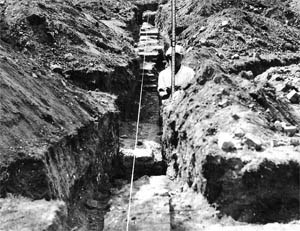 A man in a trench. A man in a trench.