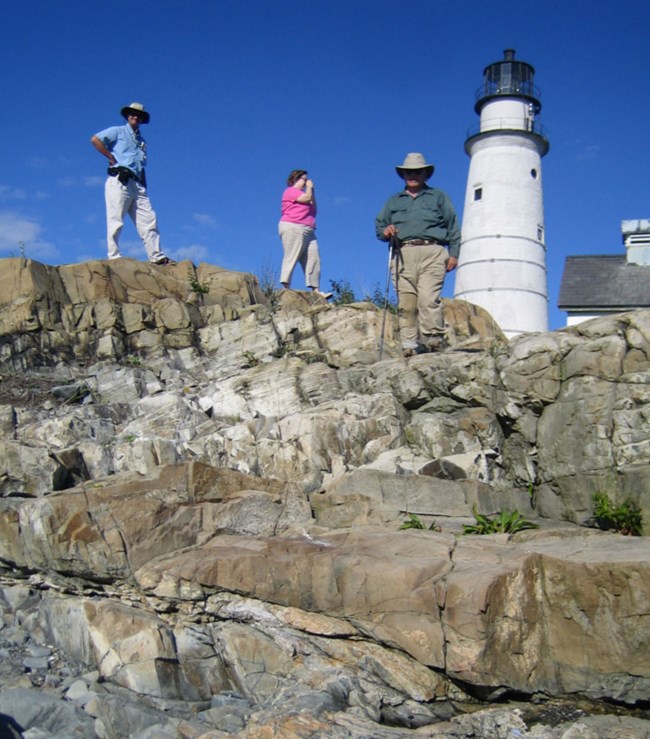 boston harbor gri photo visitors and lighthouse on rocky bluff