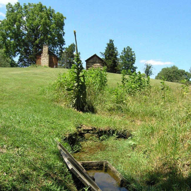 field with park cabins and spring box