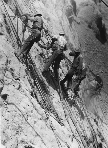 Men rappelling down side of the Hoover Dam. Men rappelling down side of the Hoover Dam.