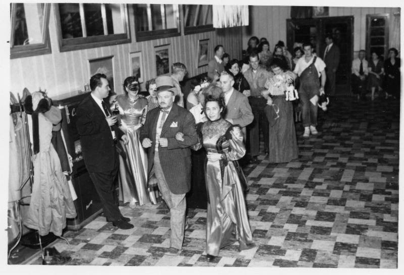 people in formal attire in a hotel lobby