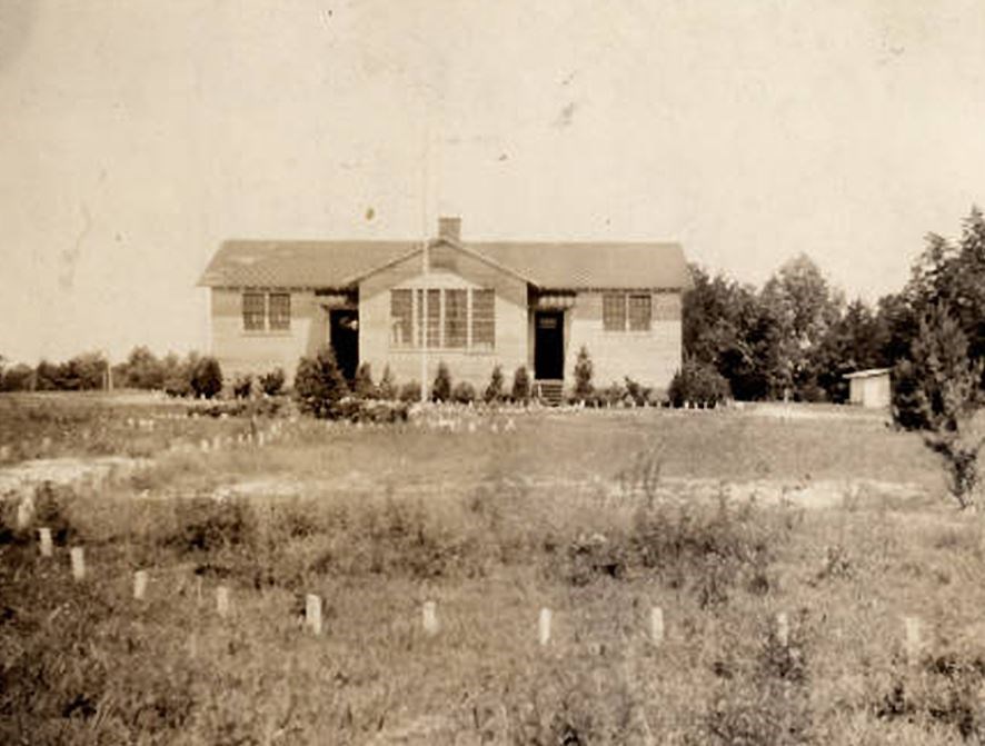 Schoolhouse in a field.