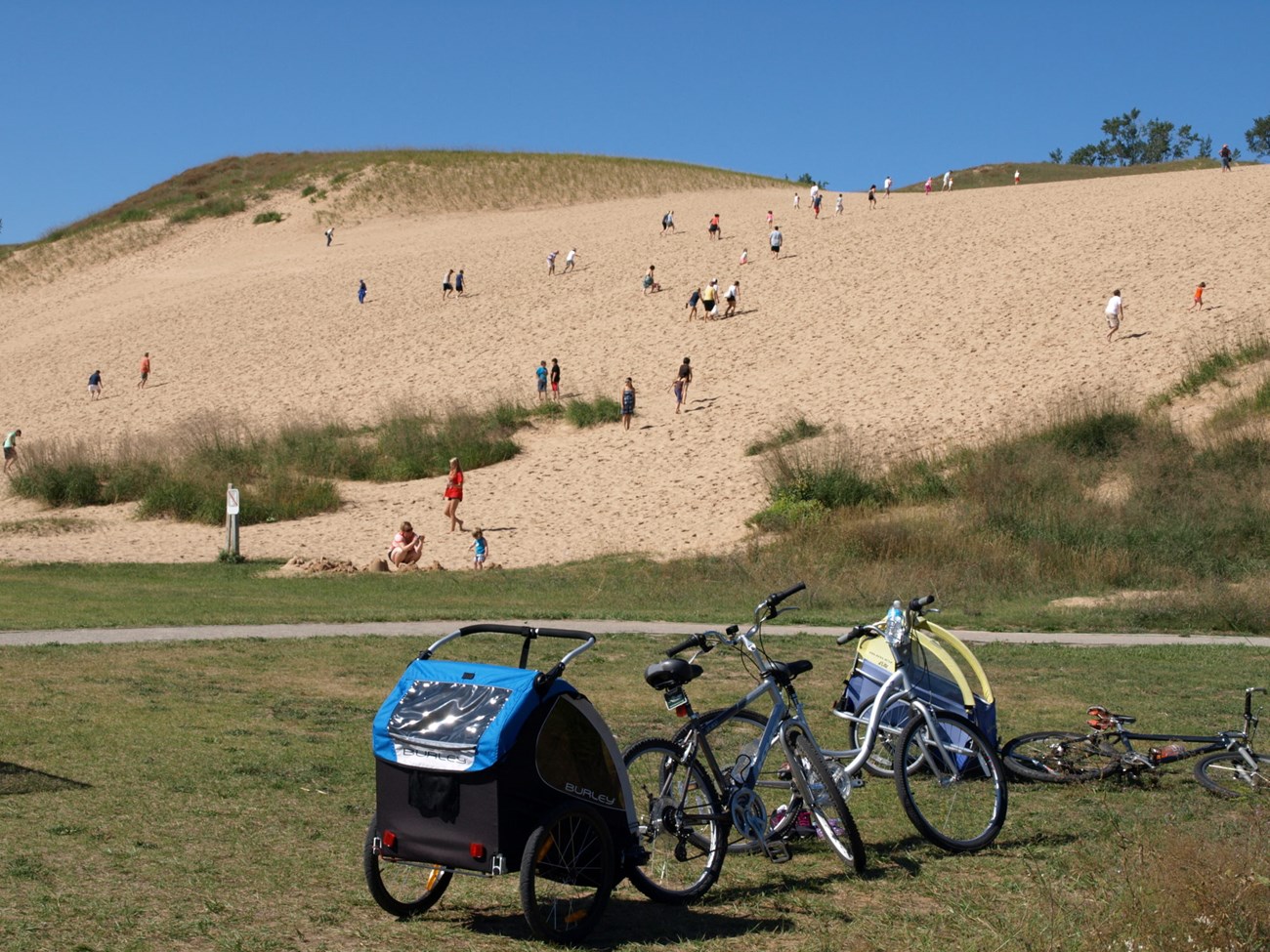 Visitors climb a sand dune at Sleeping Bear Dunes National Lakeshore. Visitors climb a sand dune at Sleeping Bear Dunes National Lakeshore.