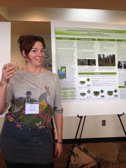 Woman standing next to a scientific poster