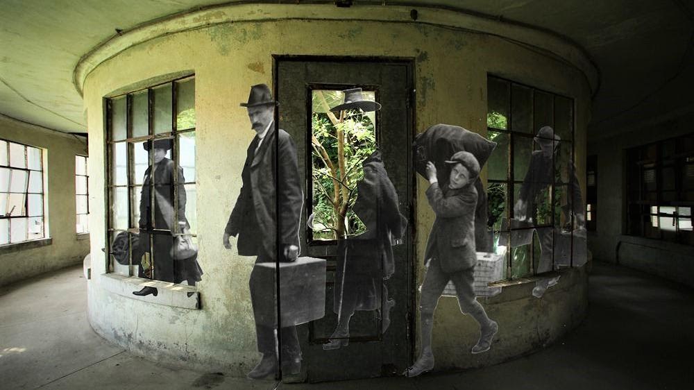 French artist, JR, installed dozens of large print historic photographs in and around derelict buildings on Ellis Island - part of the Statue of Liberty National Monument. Photo courtesy of Save Ellis Island. French artist, JR, installed dozens of large print historic photographs in and around derelict buildings on Ellis Island - part of the Statue of Liberty National Monument. Photo courtesy of Save Ellis Island.