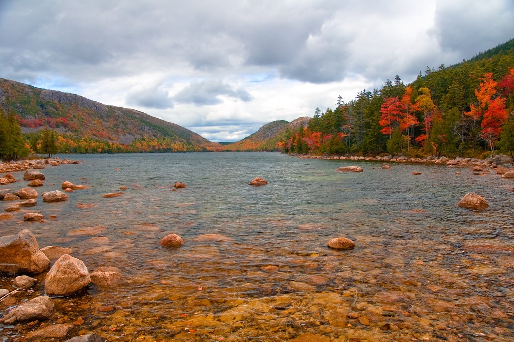 A fall day on Jordan Pond with colorful trees in the background