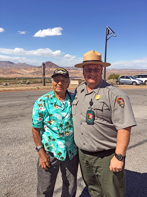 ranger stand beside a veteran outside at Lake Mead