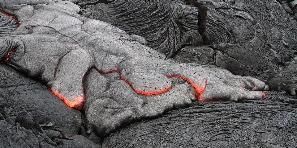 Gray and red lava on top of black hardened lava Gray and red lava on top of black hardened lava