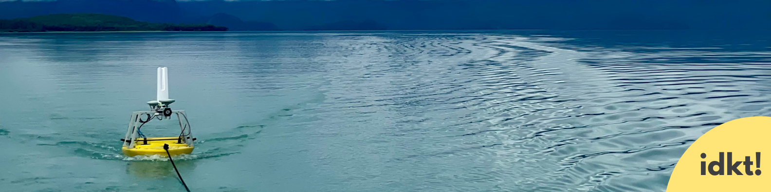 a banner image with a small yellow boat being pulled by a rope on a blue lake. A small icon with the text "IDKT" is in the right corner of the image