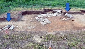 Excavated archeological unit showing stone features.