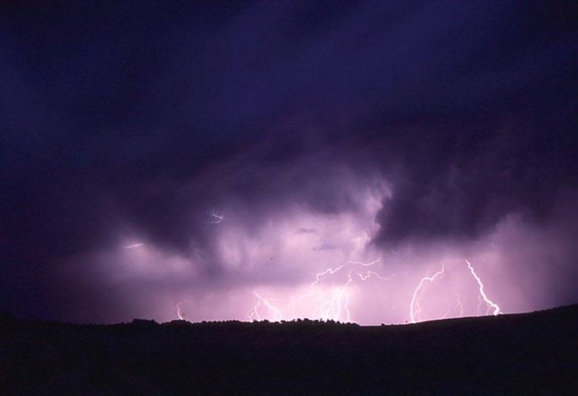 lightning strikes at Natural Bridge National Monument lightning strikes under dark skies