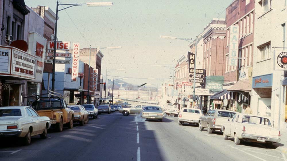 Historic street scene with buildings and cars