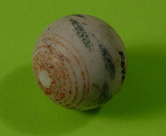 Marble with painted decoration.