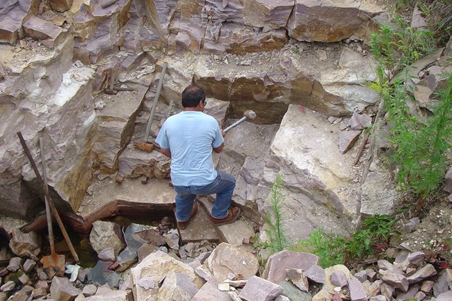 A man hammering in a quarry