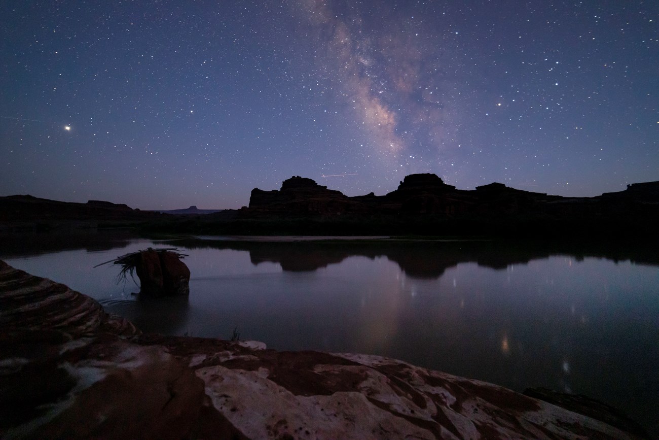 Milky Way Reflection in CO River A clear reflection of the Milky Way Galaxy can be seen in the river and sky, with silhouetted ridges in the background.