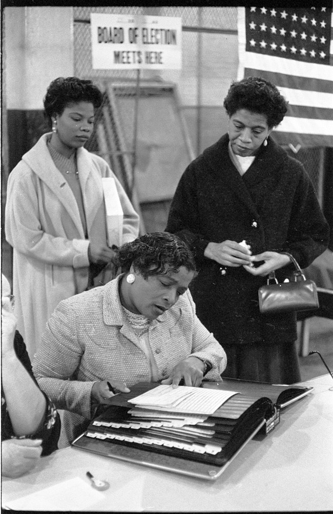 Three women at polling place. Library of Congress.