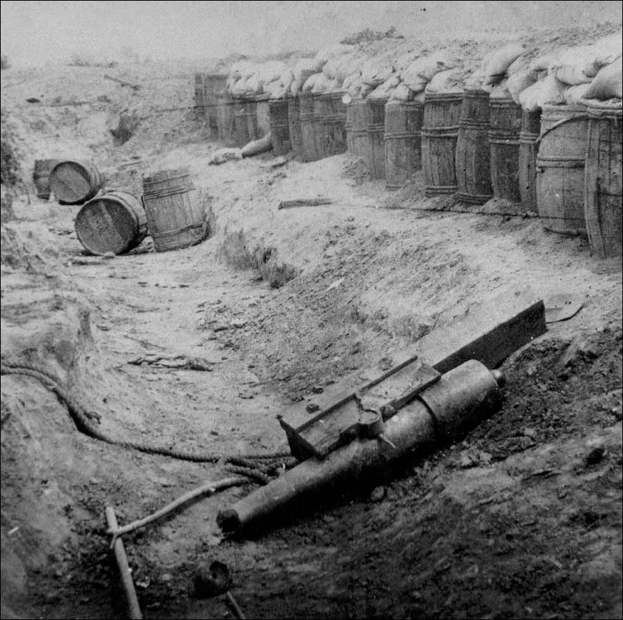 Photo of a Confederate cannon side the siege works.