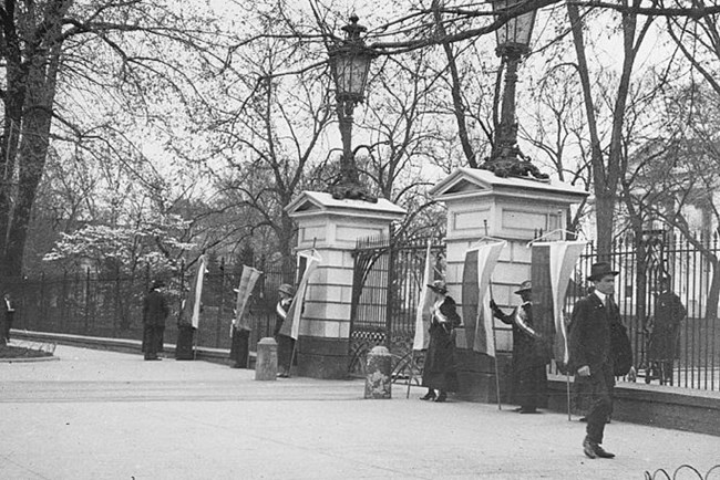 Suffragists picketing the White House in 1917. Multiple women were arrested for obstructing the sidewalk and sent to jail, including women from Delaware. Library of Congress, Harris & Ewing Collection. Suffragists picketing the White House in 1917. Multiple women were arrested for obstructing the sidewalk and sent to jail, including women from Delaware. Library of Congress, Harris & Ewing Collection.