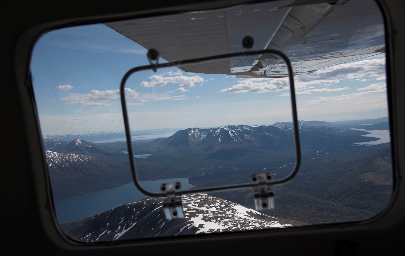 Mountains and lakes from a plane window A view of mountains and lakes from a plane window