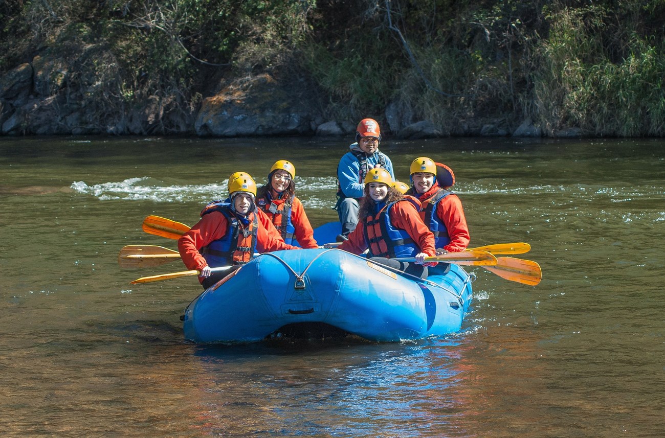 rafting people in a raft on a river