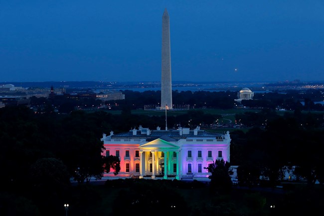 The Exterior of the White House bathed in rainbow colors. Photo by US Department of State.