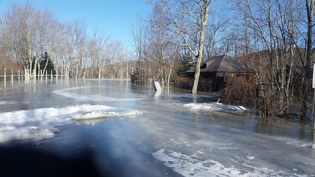 ice covered parking lot with closed building in the background
