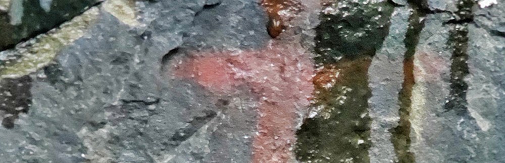 rock art_cropped_web2 Rock art face with water on it.