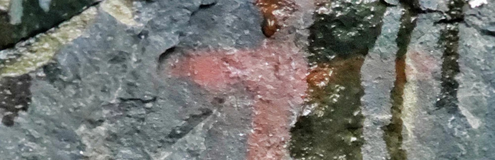 rock art_cropped_web2 Rock art face with water on it.